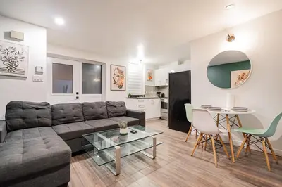 a living room with a couch and a table at Griffintown Urban Nest 2BR Comfort in Montréal