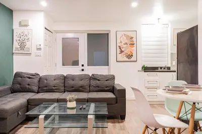 a living room with a couch and a table at Griffintown Urban Nest 2BR Comfort in Montréal