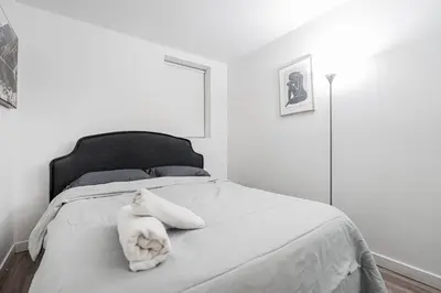 a white bedroom with a white stuffed animal on a bed at Griffintown Urban Nest 2BR Comfort in Montréal