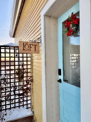 a door to a house with a left sign on it at Loft à la campagne in Waterville
