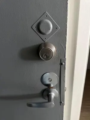 a door with a metal door knob and a door pull at Appartment 1 bedroom in Longueuil