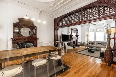 a living room with a large wooden table and chairs at Au coeur du plateau in Montréal