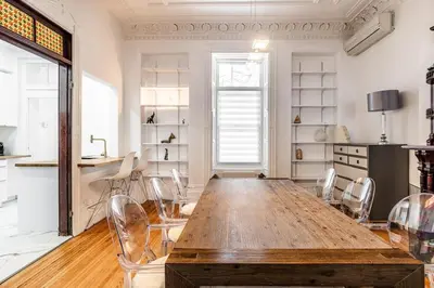 a dining room with a large wooden table and chairs at Au coeur du plateau in Montréal