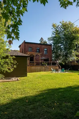 a large yard with a house in the background at Historical Home - Near Montreal in Longueuil