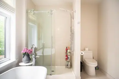 a bathroom with a shower and a toilet at Historical Home - Near Montreal in Longueuil