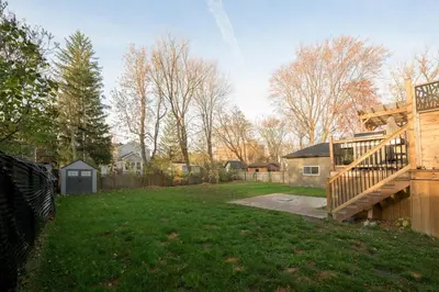 a yard with a wooden fence and a house at Historical Home - Near Montreal in Longueuil