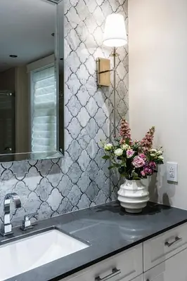 a bathroom with a sink and a vase of flowers on a counter at Historical Home - Near Montreal in Longueuil