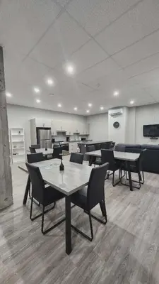 a dining room with tables and chairs in a room at La Baraque in Thetford Mines