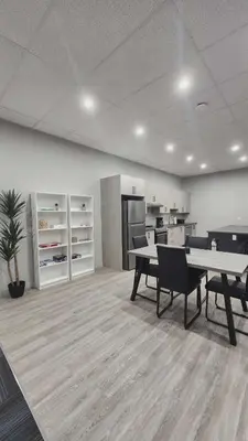 an office with tables and chairs and a kitchen at La Baraque in Thetford Mines