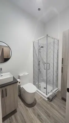 a bathroom with a toilet and a glass shower at La Baraque in Thetford Mines