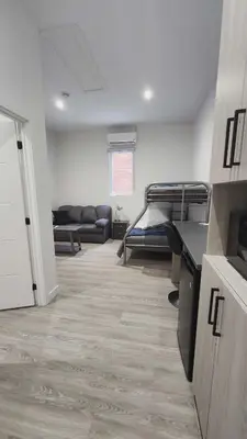 a large room with a bed and a couch in it at La Baraque in Thetford Mines