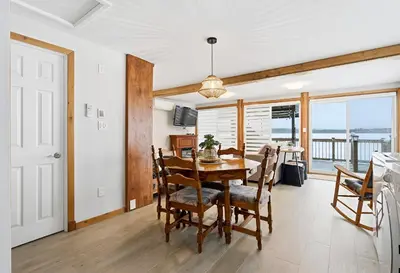 a kitchen and dining room with a table and chairs at 232 on the Lake Ski, Golf, Snowmobile in Adstock