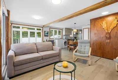 a living room with a couch and a table at 232 on the Lake Ski, Golf, Snowmobile in Adstock