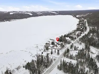 an aerial view of a road in the snow next to a lake at 232 on the Lake Ski, Golf, Snowmobile in Adstock