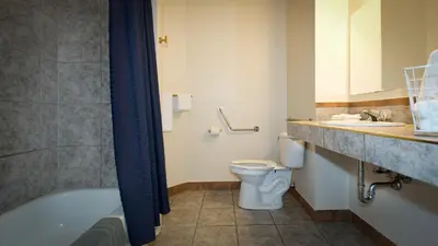 a bathroom with a tub and a toilet and a sink at Motel De La Gare Richmond in Richmond