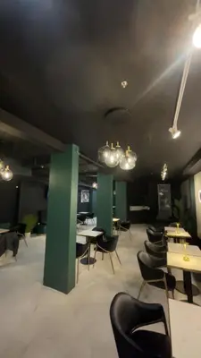 a large room with tables and chairs and lights at Carbone in Montréal