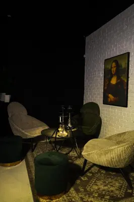 a room with chairs and a table and a painting at Carbone in Montréal