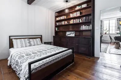 a bedroom with a bed and a book shelf at Unique 1847 Heritage Retreat - Garden - 2 Parkings in Montréal