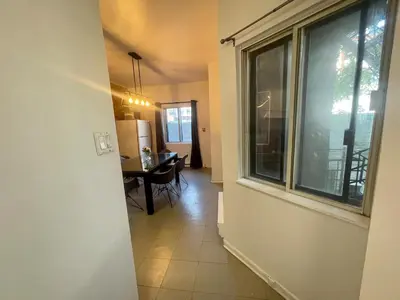 a hallway with a dining room table and a window at FULL KITCHEN 12min from DTOWN Room B in Montréal