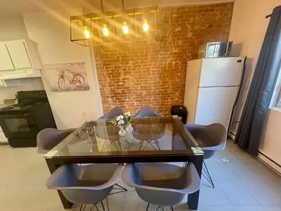 a dining room table with chairs and a glass top at FULL KITCHEN 12min from DTOWN Room B in Montréal