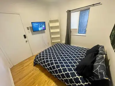 a bedroom with a bed and a window and a television at FULL KITCHEN 12min from DTOWN Room B in Montréal
