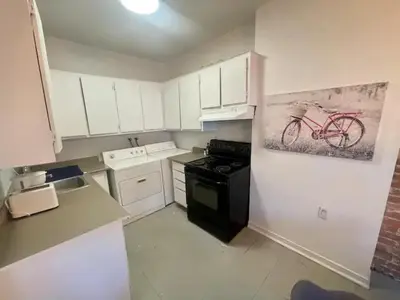 a kitchen with a red bike painting on the wall at FULL KITCHEN 12min from DTOWN Room B in Montréal