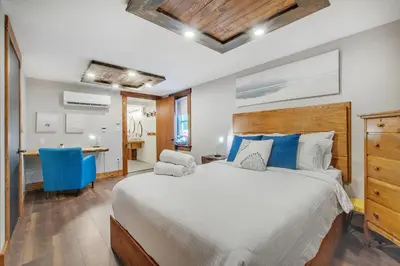 a bedroom with a large bed and a desk at auxportesdesMilleIles in Laval