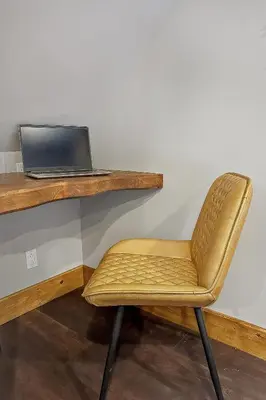a chair sitting in front of a desk with a laptop at auxportesdesMilleIles in Laval