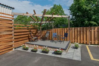a patio with a table and chairs and a wooden fence at auxportesdesMilleIles in Laval