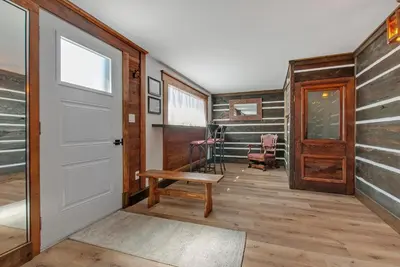 a hallway with a door and a bench in a room at auxportesdesMilleIles in Laval