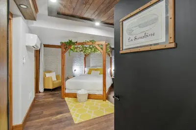 a bedroom with a bed with a canopy at auxportesdesMilleIles in Laval