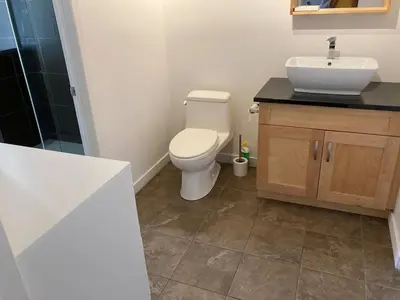 a bathroom with a toilet and a sink at Beautiful bright apartment in Montréal