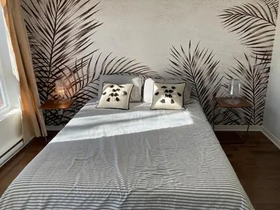 a bedroom with a bed with two pillows at Beautiful bright apartment in Montréal