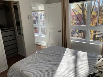 a bedroom with a bed and a window at Beautiful bright apartment in Montréal