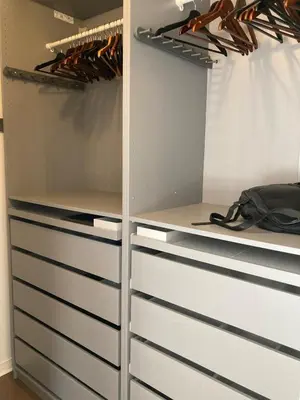 a walk in closet with white drawers at Beautiful bright apartment in Montréal
