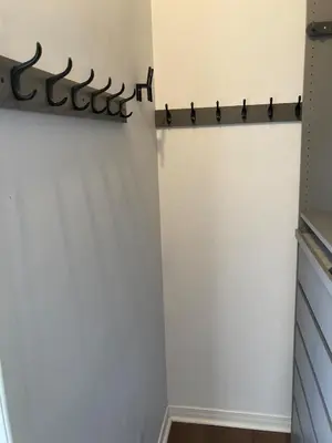 a closet with a white wall with a black sign on it at Beautiful bright apartment in Montréal