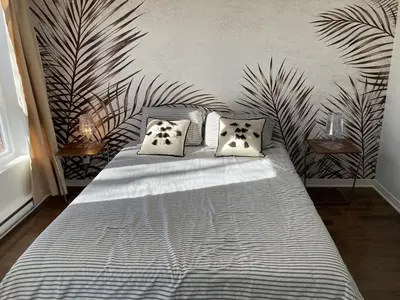 a bedroom with a large bed with two pillows at Beautiful bright apartment in Montréal