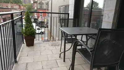 a patio with a table and chairs on a balcony at Magnifique appartement Montréal Centre-Ville in Montréal