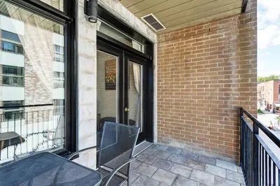 a patio with a table and a chair on a balcony at Magnifique appartement Montréal Centre-Ville in Montréal