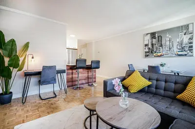 a living room with a couch and a table at Appartement chaleureux pour un séjour parfait in Montréal