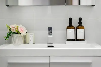 two bottles of wine on a counter with flowers at Charming Champs Élysées -Old Montreal-Downtown Montreal - Laundry in Montréal