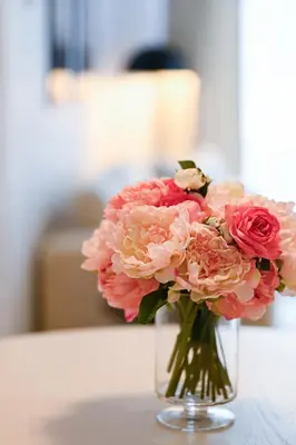 a vase filled with pink flowers on a table at Charming Champs Élysées -Old Montreal-Downtown Montreal - Laundry in Montréal