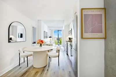 a dining room with a white table and chairs at Charming Champs Élysées -Old Montreal-Downtown Montreal - Laundry in Montréal