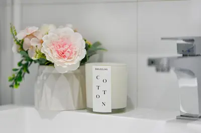 a candle and a vase with flowers on a counter at Charming Champs Élysées -Old Montreal-Downtown Montreal - Laundry in Montréal