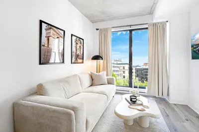 a living room with a couch and a table at Charming Champs Élysées -Old Montreal-Downtown Montreal - Laundry in Montréal