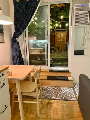 a kitchen with a table and a sliding glass door at Montreal Hideaway in a Residential area in Montréal