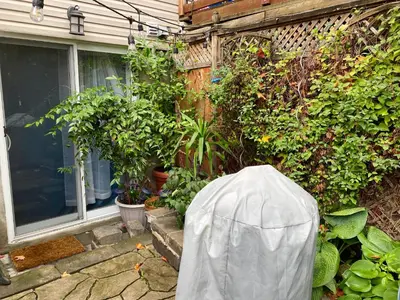 a garden with potted plants and a house at Montreal Hideaway in a Residential area in Montréal
