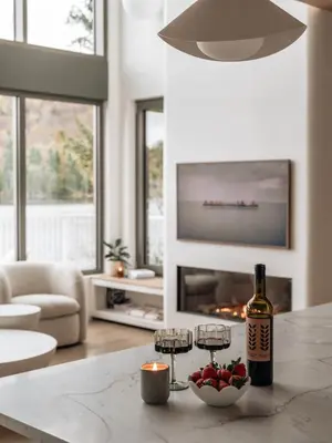 a living room with a bottle of wine and wine glasses at Wild Pond Villa in Mansonville