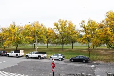 a parking lot with cars parked in a park at 2CAC rénover, tranquille, près du parc, commodités et activités in Montréal