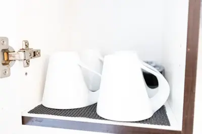 two white coffee makers sitting on a shelf at 2CAC rénover, tranquille, près du parc, commodités et activités in Montréal
